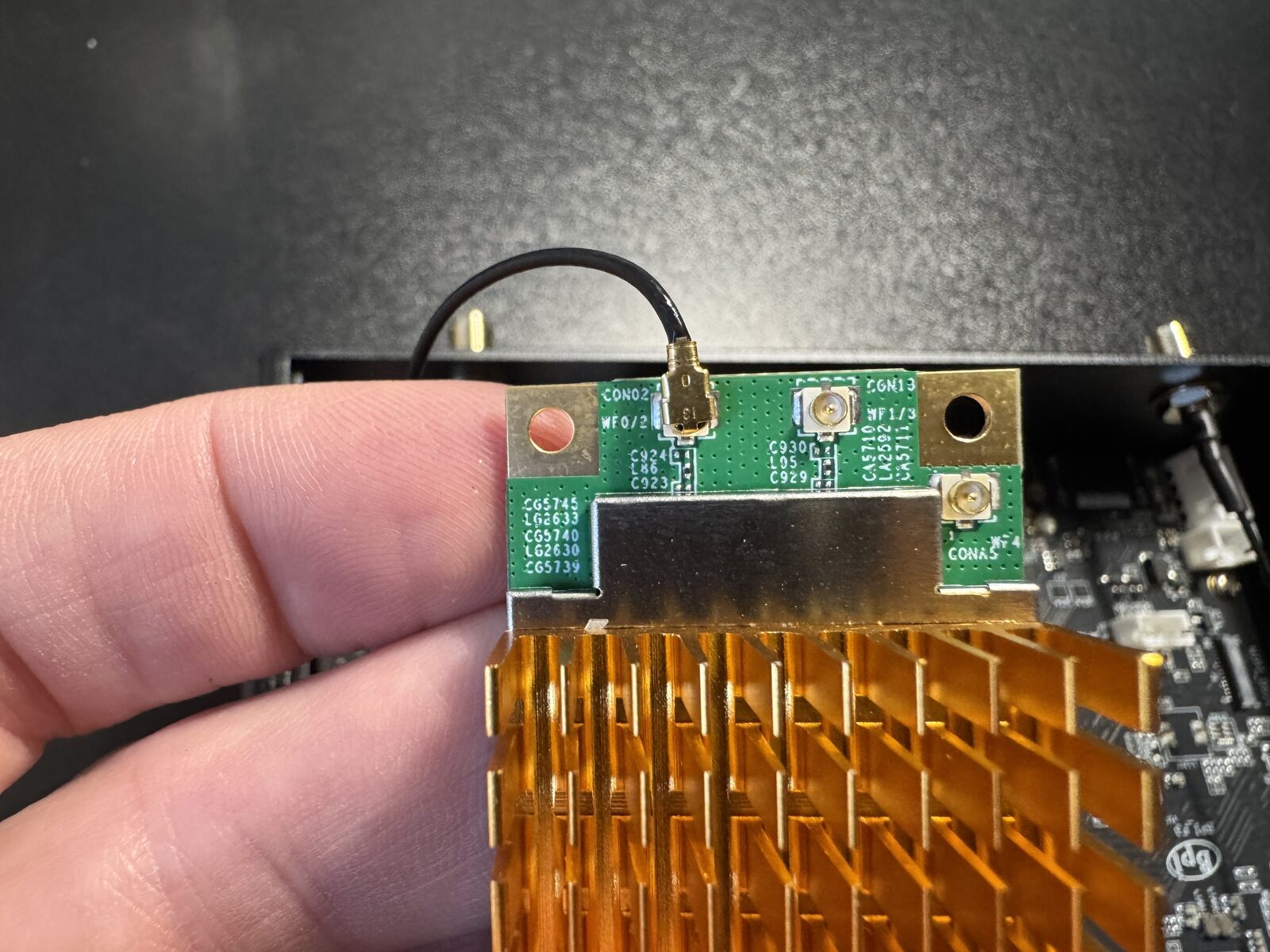 An antenna connector seated flat on the module’s socket