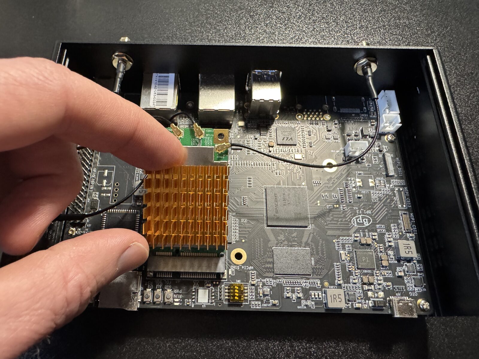 Sliding the module into the mini PCIe slot